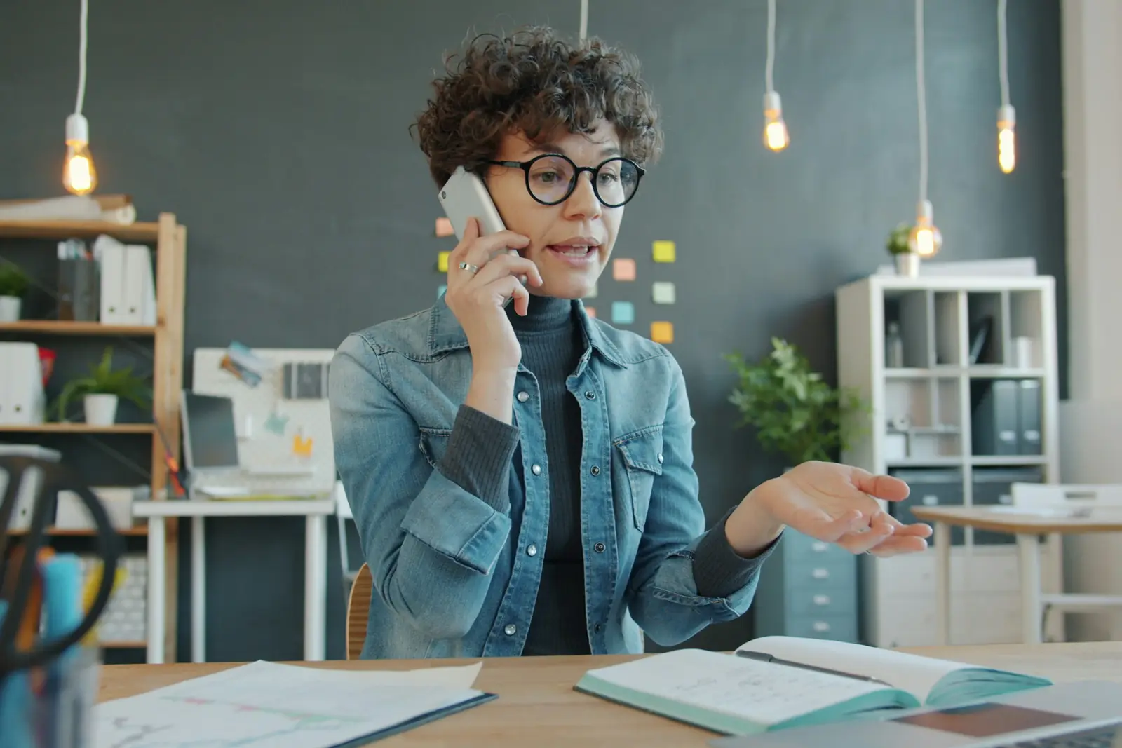 Customer care team member on a phone call at her desk
